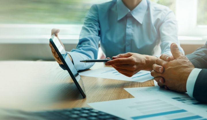 two people looking at an ipad
