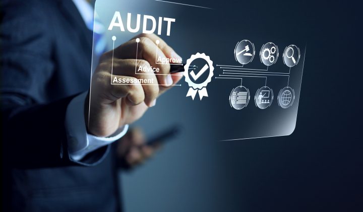 Audit concept with auditor using a pen to tick checkmark to approve the evaluation scope activity for annual assessment in standards requirement scope