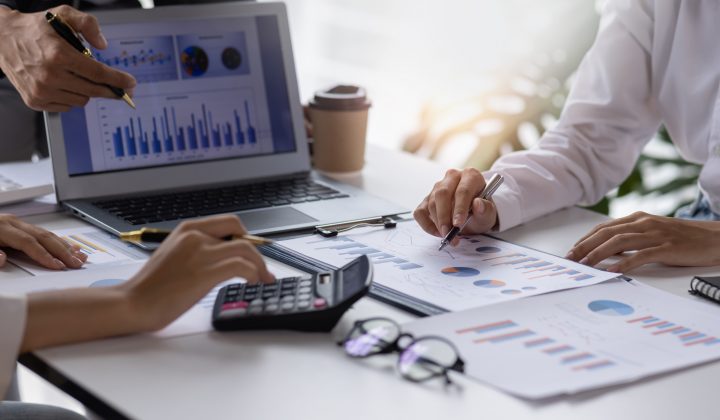 Team of Business people working at workplace with tablet and document, doing planning analyzing Tax financial report, business plan investment, finance analysis Economic business discussions.