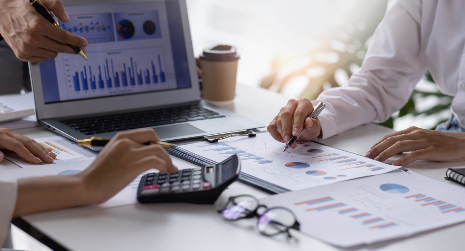 Team of Business people working at workplace with tablet and document, doing planning analyzing Tax financial report, business plan investment, finance analysis Economic business discussions.