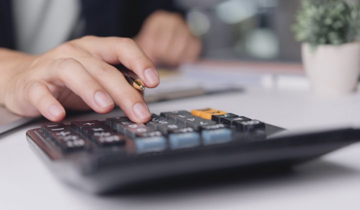 Accountant calculates expenses pressing calculator on office desk, finance budgeting tax audit bookkeeping accuracy business numbers management concept minimal workspace