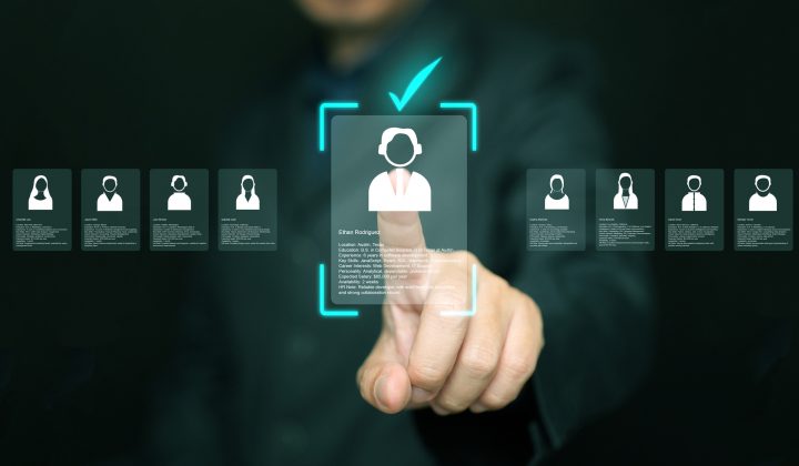 Human resources manager analyzing applicant profiles on virtual screen. Modern concept of digital recruitment, AI candidate selection, HR analytics, and smart hiring technology in business.